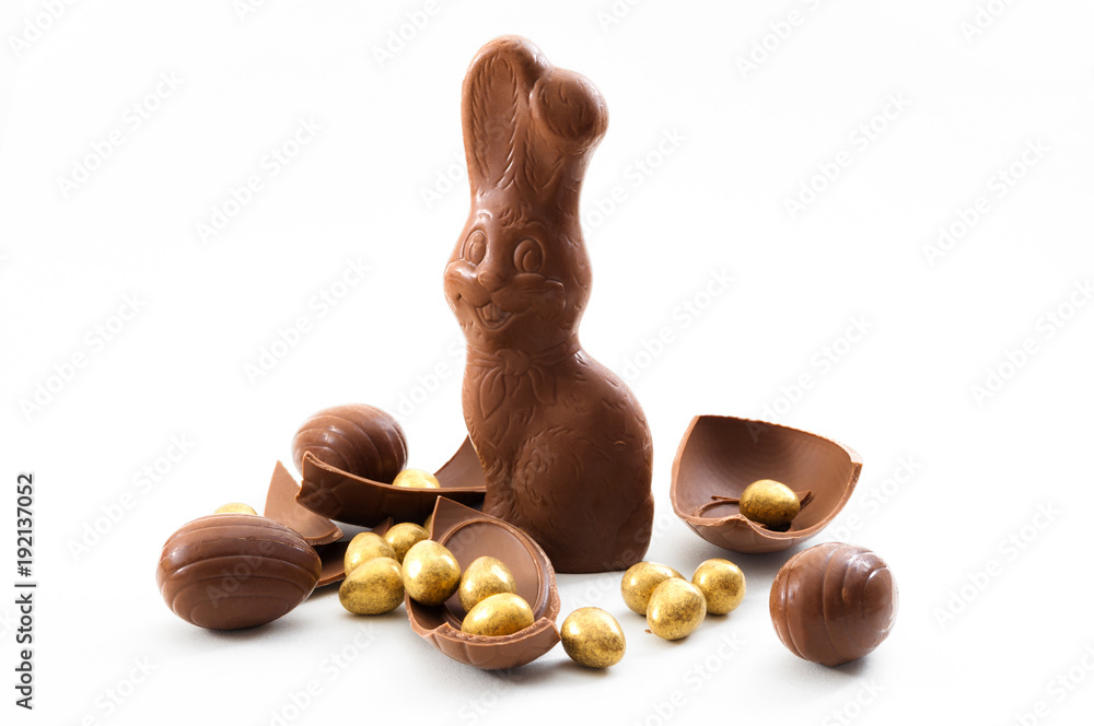 Wall mural passover, happy easter and good friday wishes concept with a chocolate bunny surrounded by pieces of