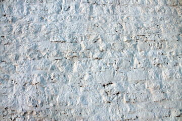  texture of an ancient brick wall covered with white mortar for the background