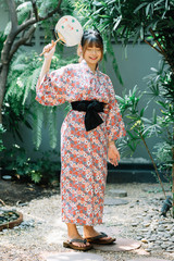 Lifestyle series: Asian woman in yukata holding paper fan