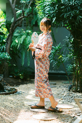 Lifestyle series: Asian woman in yukata holding paper fan