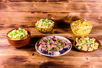 Different festive dishes on a wooden table