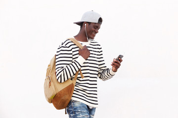 handsome young black man with bag looking at his phone