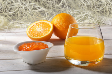 Orange jam and juice in glass. Morning breakfast.