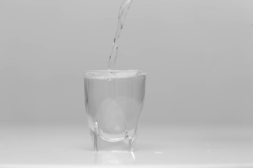 Full water glass in a studio