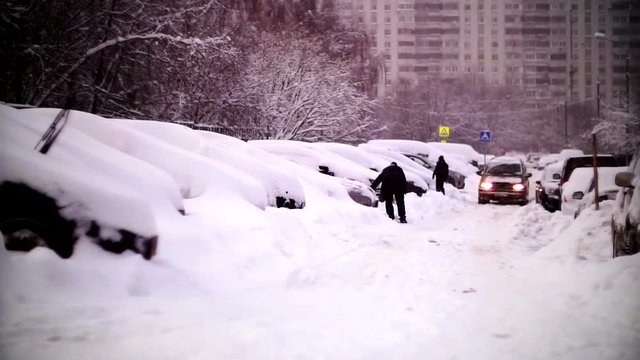Cars covered with snow in a residential area of Moscow.