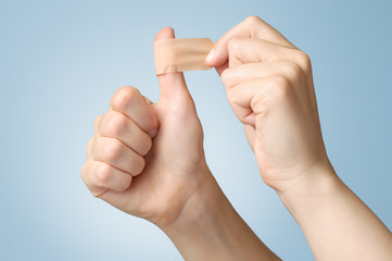 Woman with a plaster on her thumb