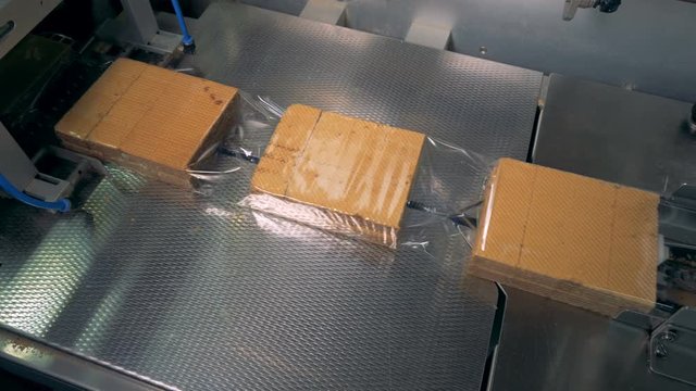 Packing food. Cookies being packed into containers, packages. Grocery retailers and distribution concept.