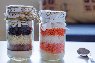 Close up of home made jars for decoration. Natural seeds. beans, rice, salt, coffee.