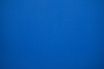 Blue colored corrugated cardboard texture useful as a background