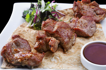 Pork shish kebab on a white plate
