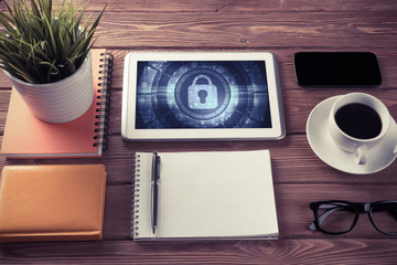 Web security and technology concept with tablet pc on wooden tab