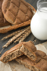 Brown rye breadcrumbs and a glass decanter of milk