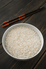 Raw Basmati rice grits in white porcelain bowl