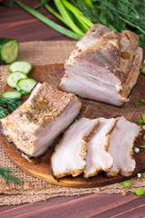 Ukrainian traditional food - salo. Sliced bacon with onion on wooden background