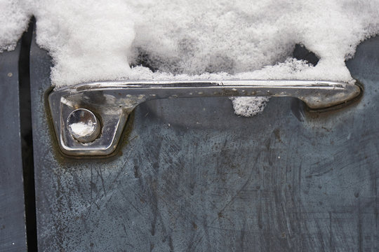 Handle of russian vintage car covered with snow