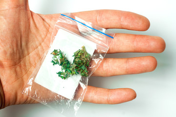A packet with a dose of medicinal hemp according to the doctor's prescription for the treatment of nerves in the hands of a person