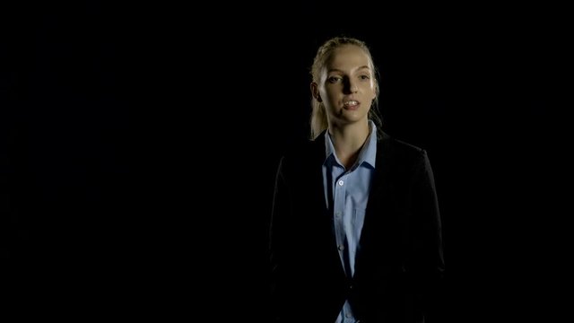 Beautiful businesswomen giving an interview on black background