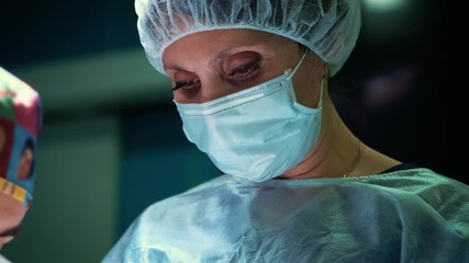 Close up of a female surgeon's eye. Portrait of surgeon woman during surgery