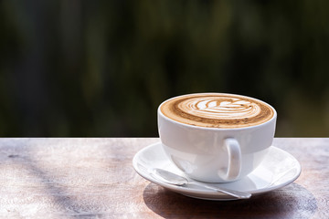 Fototapeta na wymiar Coffee cup on wooden table,latte art