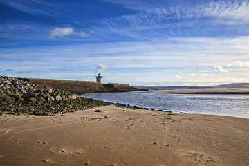 Fototapeta na wymiar Georgian Lighthouse at Burry Port, Carmarthenshire, Wales, near the Gower Peninsula at the Loughor Estuary