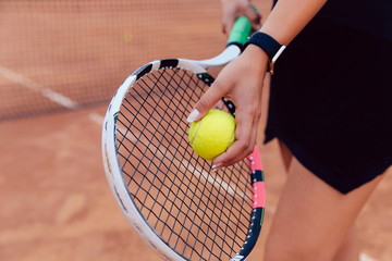 Tennis player. Close-up view of women's hand preparing to hit a ball, playing tennis on the court.