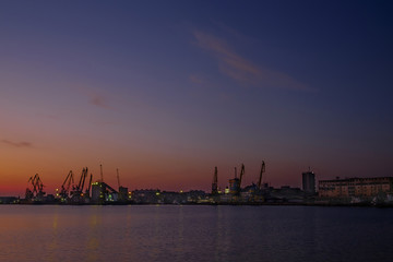 Naklejka premium Sunset over the seaport 2