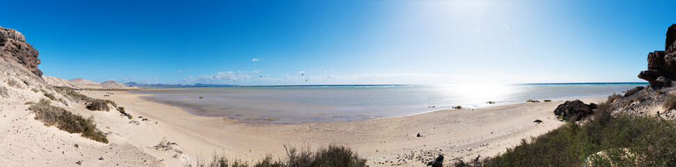 panorama shot of Sotavento Playa wide sand beach and blue ocean on sunny day on Fuerteventura