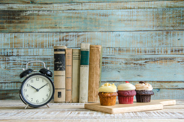cupcake on wooden table on vintage background