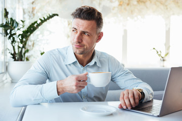 Portrait of a handsome mature man using laptop computer
