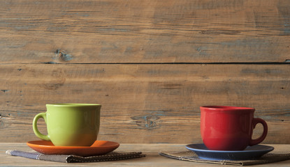 coffee cup with plate on wooden texture table