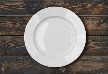 white empty dinner plate on wood table