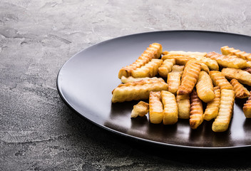 Deep fried french potatoes on dark table