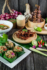 Spicy Raw Ant Eggs Salad, Oxtail soup, grilled ox tongue, deep fried beef on the table with herbs