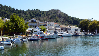 Fototapeta na wymiar THASSOS, GREECE- September 13, 2015: Traditional Fishing boats in old Thassos harbor ( Limenas ), in Thassos island, Greece