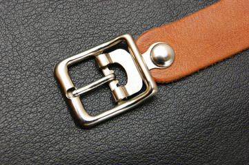 belt  with a buckle on a black leather