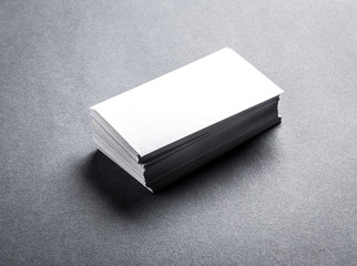 Fototapeta premium Stack of blank white business card on grey background. Blank name card.