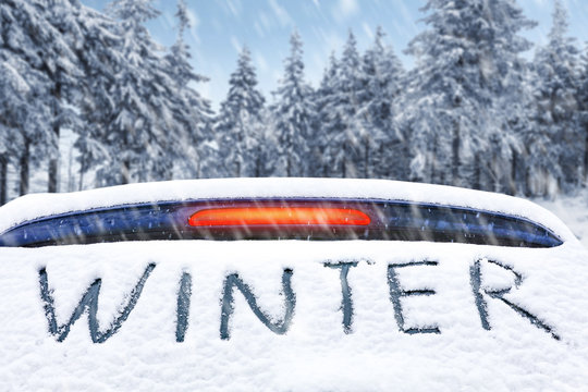 A Snow-covered Car With A Ski Rack For A Very Cold Winter Day   