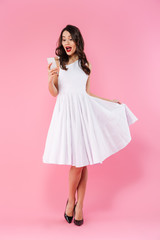 Full length portrait of a surprised young asian woman