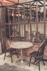 table and chairs in front of historic wall