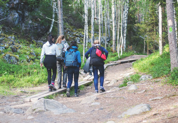 Obraz premium Four girls walking on a hiking trail