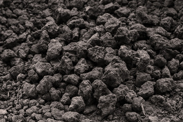 Background from black soil. Textured surface. Soil consists of a solid phase of minerals and organic matter, as well as a porous phase that holds gases and water for use organic gardening, agriculture