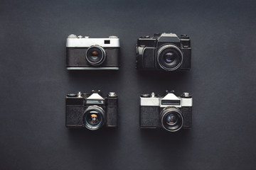 Design Creativity Technology Concept. Retro Film Cameras On Black Background Surface