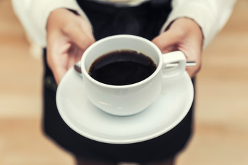 waitress serving coffee cup close up of hand showing coffee