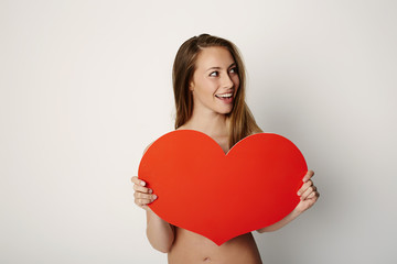 Beautiful woman with a Valentine heart, studio