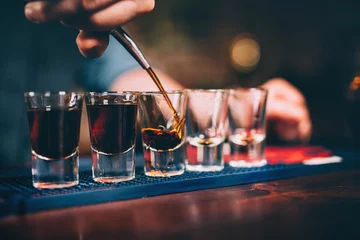 Fototapete Bar Barkeeper schenkt und serviert alkoholische Getränke an der Bar