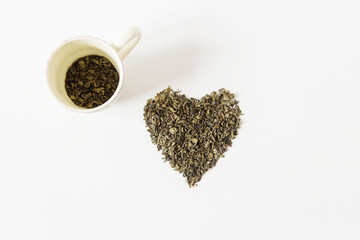 dry green tea with cup.white background.top view