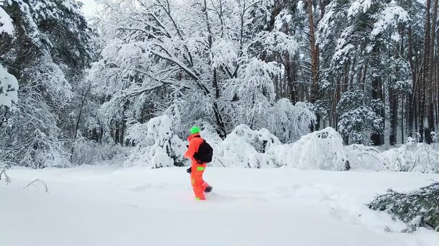Photographer making a photo of winter snowy forest.