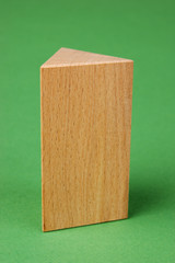 wooden geometric shapes on a green background