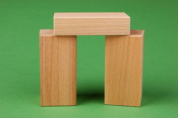wooden geometric shapes on a green background