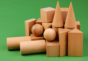 wooden geometric shapes on a green background